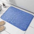 Alfombrilla de baño azul de Variedad Online con diseño de guijarros, textura suave y absorbente.