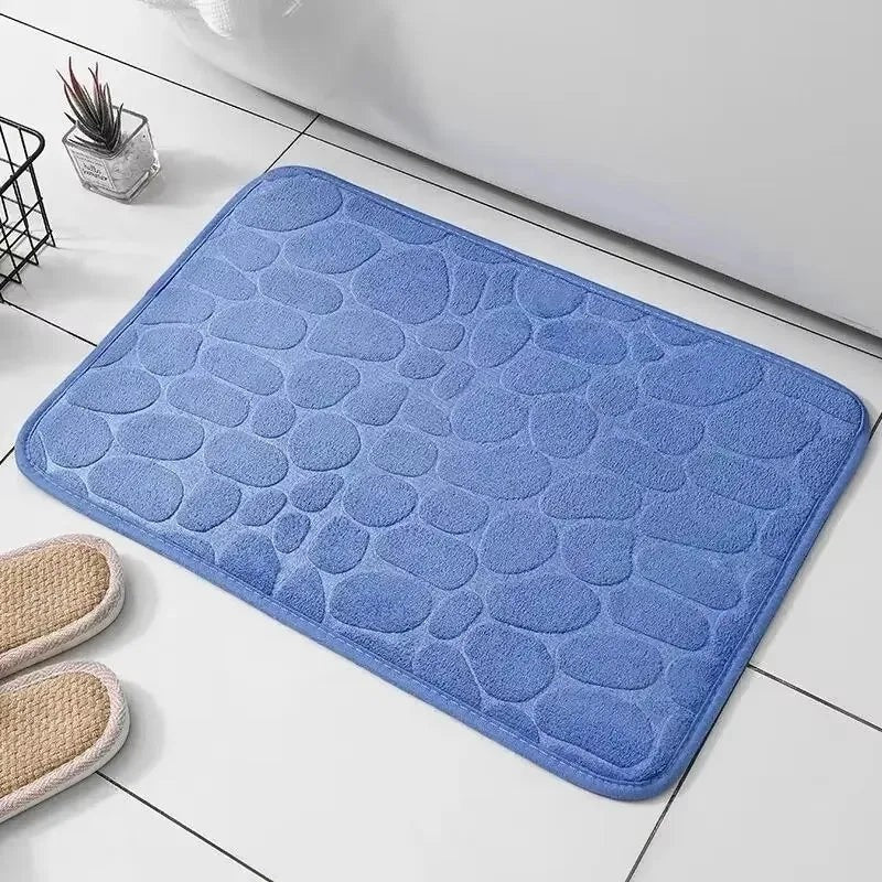 Alfombrilla de baño azul de Variedad Online con diseño de guijarros, textura suave y absorbente.