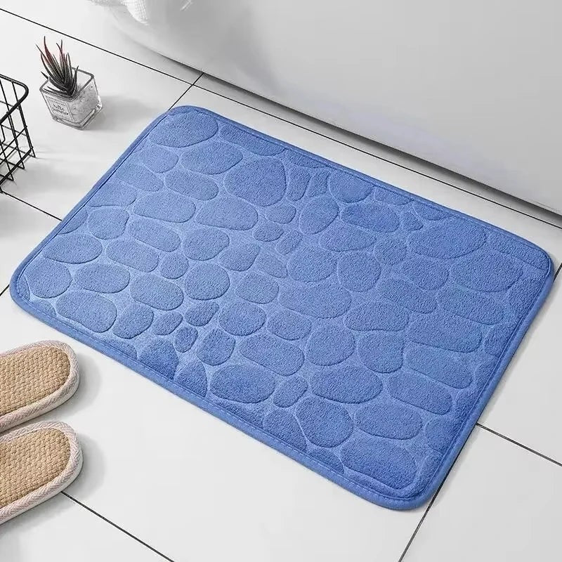 Alfombrilla de baño azul de Variedad Online con diseño de guijarros, suave y absorbente.