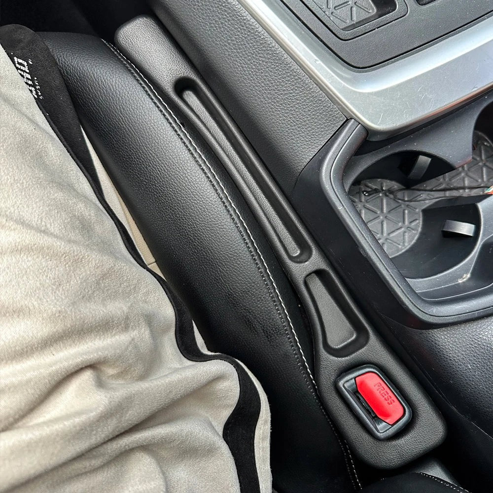 Organizador de huecos para asientos de coche de cuero negro de Variedad Online con costuras blancas, ideal para evitar caídas y mantener el orden.